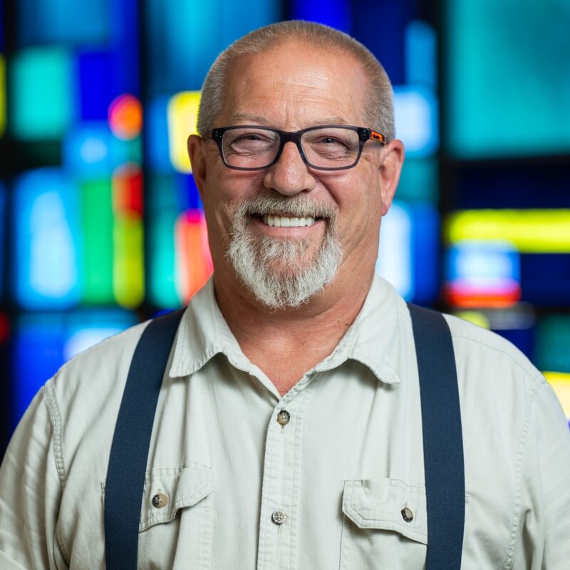 man in church wearing suspenders